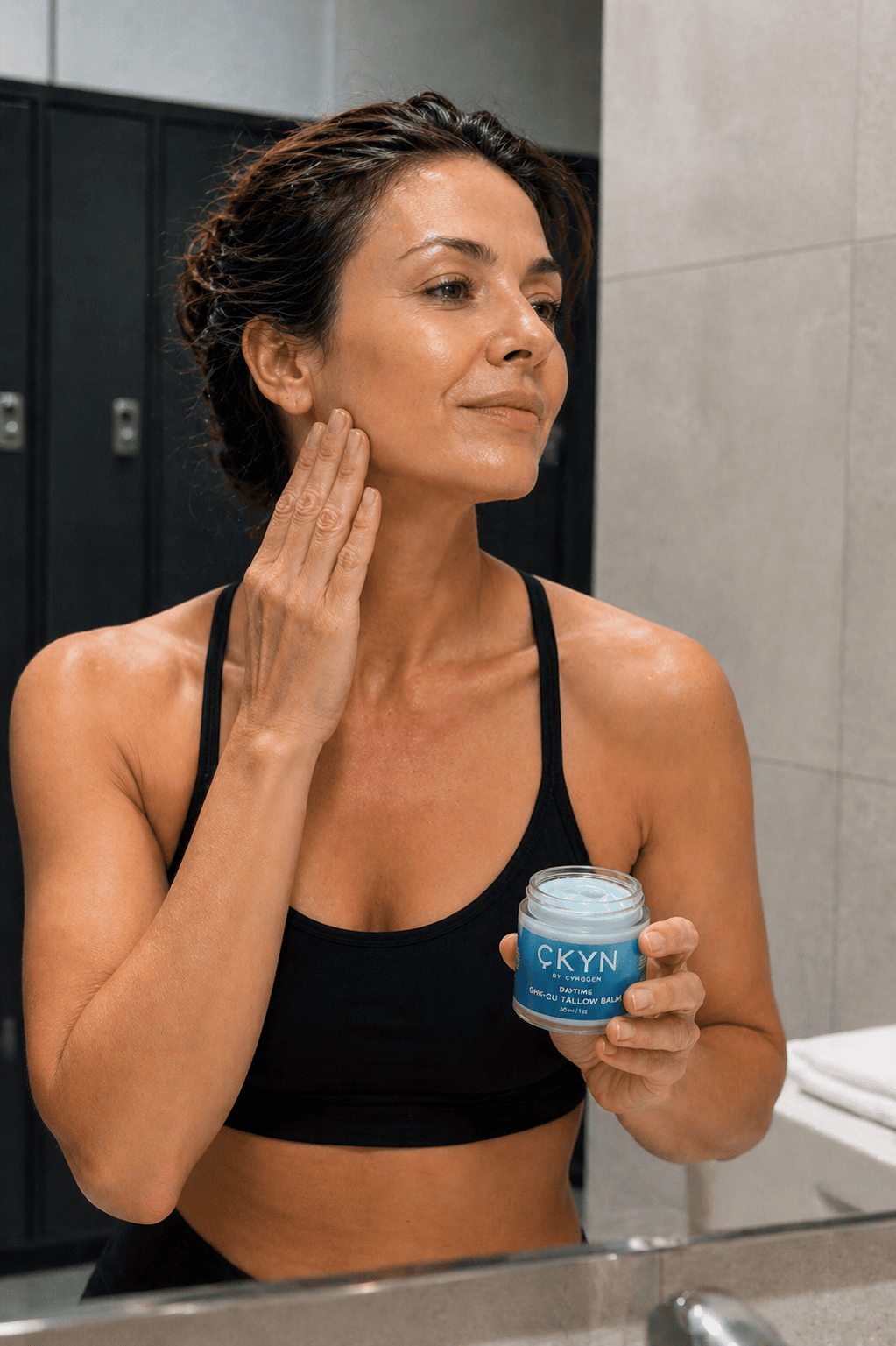 Woman applying CKYN Tallow Balm after a workout